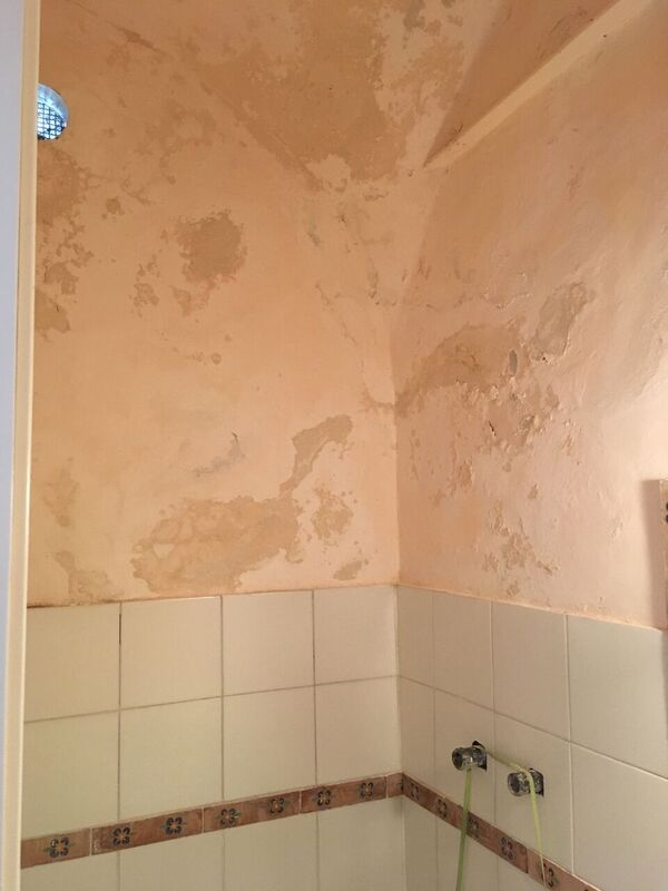 Bathroom wall damaged by water leakage